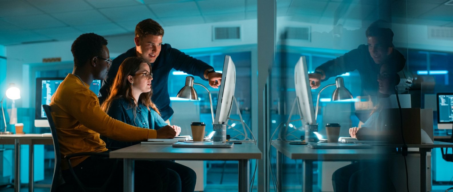 A team collaborating in an office at night